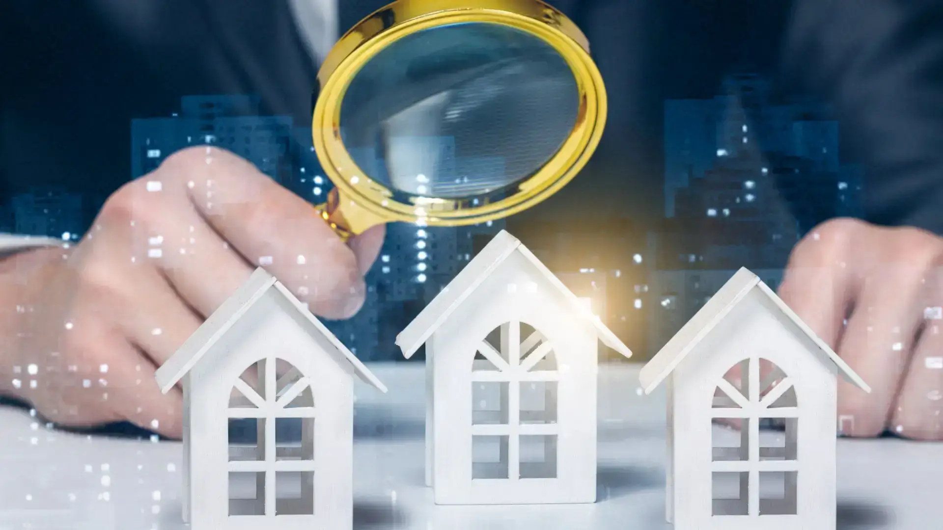 Maisons miniatures observées avec une loupe, pour illustrer la recherche de propriété dans un projet d’investissement immobilier.